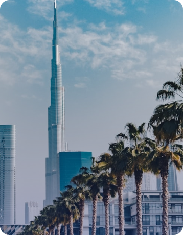 Palm-lined street in Dubai with the Burj Khalifa in the background